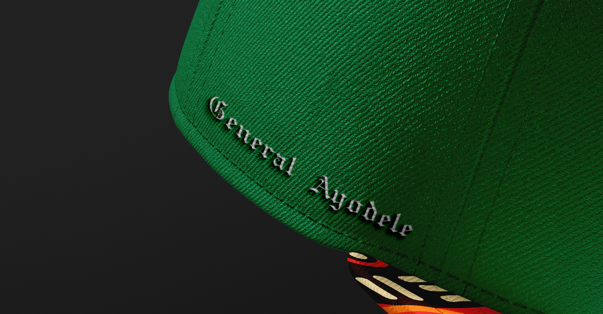 Side view of the General Ayodele Snapback highlighting the embroidered name detail and the vibrant geometric pattern on the brim.